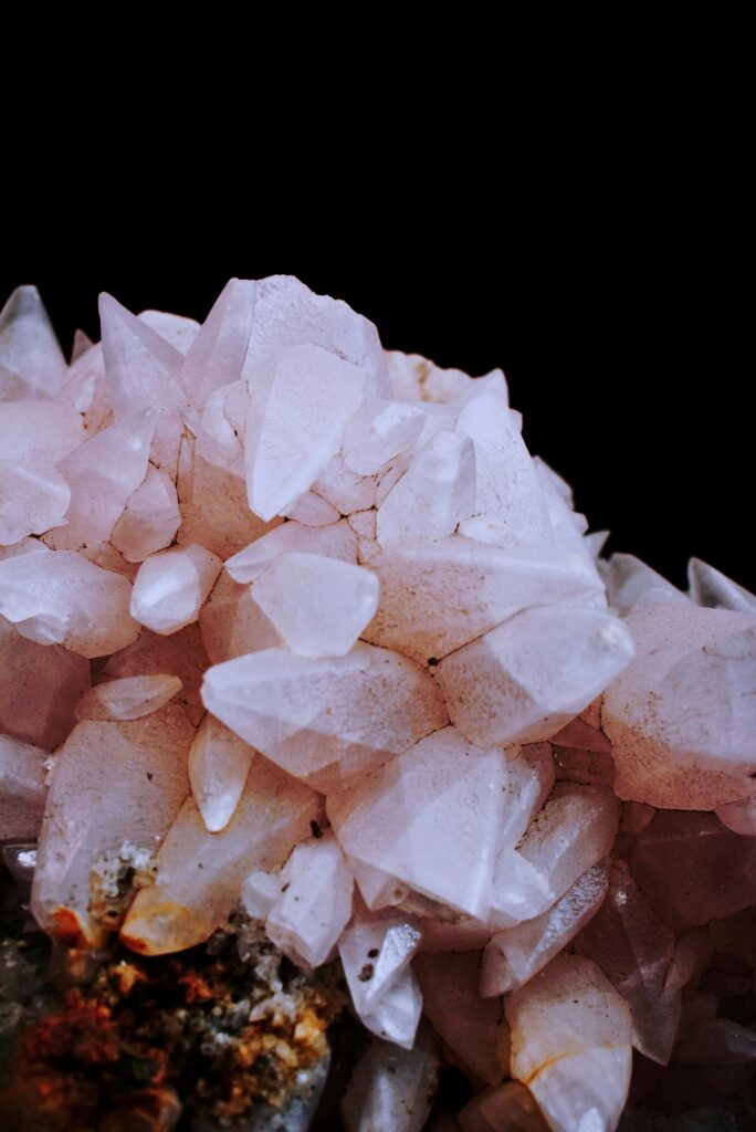 pexels-photo-2942856-2942856 Stunning close-up of pink quartz crystals with detailed facets against a dark background.